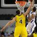 Michigan freshman Mitch McGary gets a hand on a shot by Kansas senior Travis Releford during the second half at Cowboys Stadium in Arlington, Texas on March 29, 2013. Melanie Maxwell I AnnArbor.com